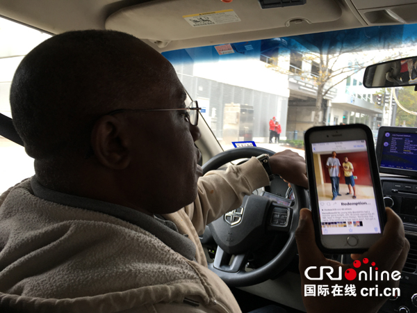 休斯敦街头的哥雅各布斯(Tony Jacobs)展示其表弟在中国的照片