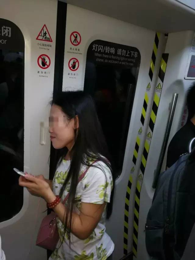 女子强闯地铁头发被夹，连续6站无法转头淡定玩手机（组图） - 2