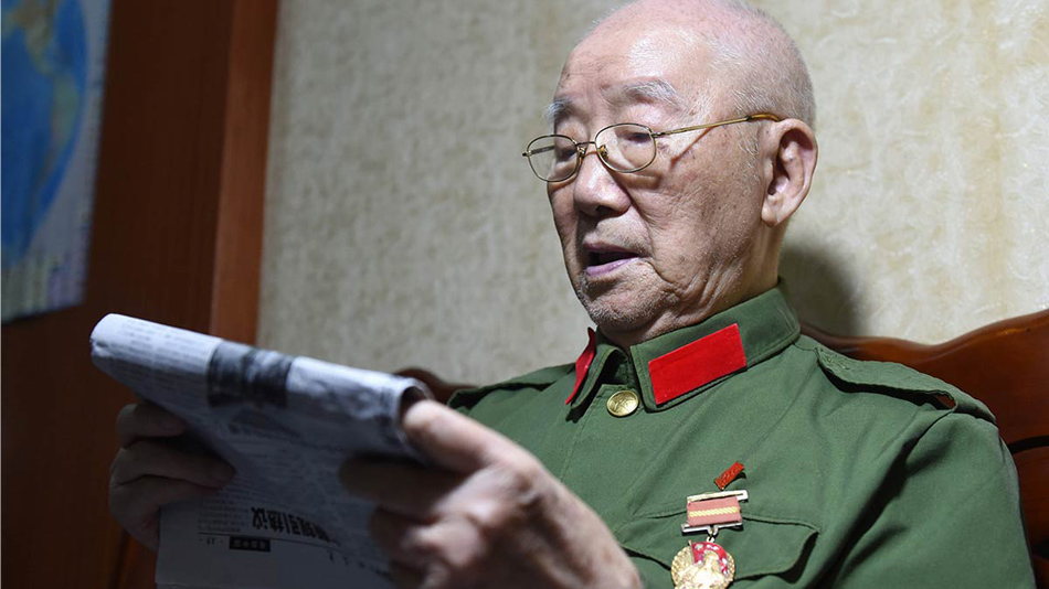 图为郝毅在广西南宁市的解放军第三〇三医院看报(10月11日摄).